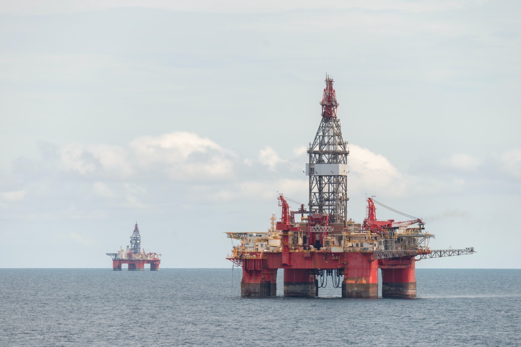 Plataformas petroleras semi-sumergibles en altamar representando la infraestructura de extracción y seguridad energética.